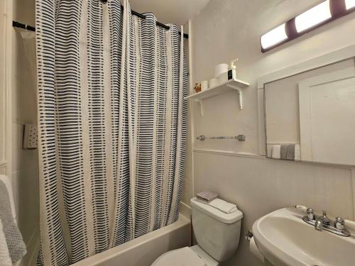 a white bathroom with a toilet and a sink at Cool and calm place to live in Memphis