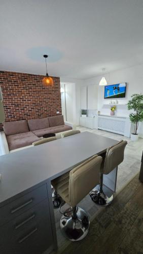 a living room with a large table and a couch at Happy Architect in Cisnădie