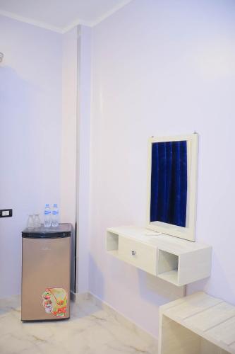 a white room with a sink and a mirror at Rayan Nubian Guest House in Aswan