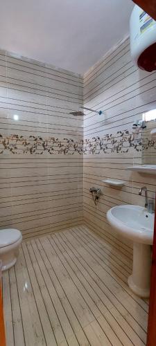 a bathroom with a sink and a toilet at Green Beach Camp & Hotel in Nuweiba