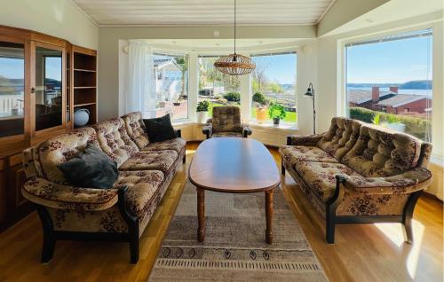 a living room with two couches and a table at 2 Bedroom Lovely Home In Uddevalla in Uddevalla