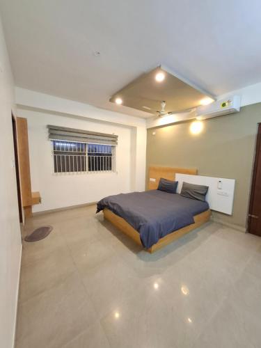 a bedroom with a bed and a window in it at Oakhaven Apartments near Mico Layout in Bengaluru