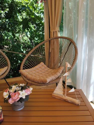 a wicker chair sitting on a table on a porch at Lavender in Baška