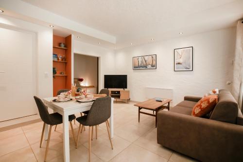 a living room with a table and a couch at Appartement 30 m de la plage in Grimaud