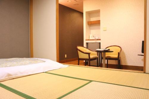 Ένα ή περισσότερα κρεβάτια σε δωμάτιο στο Nasushiobara Station Hotel