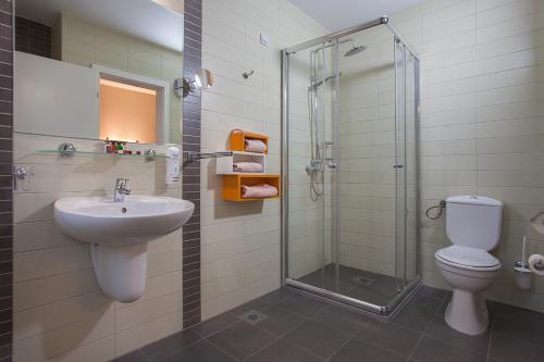a bathroom with a toilet and a sink and a shower at City Park Hotel in Skopje