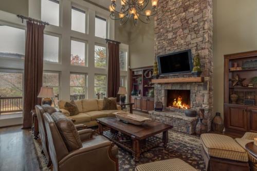 a living room with a couch and a fireplace at Grand Family Retreat 8Br With Stunning Golf Views in Mill Spring