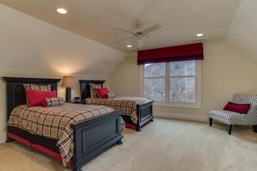 a bedroom with two beds and a window at Grand Family Retreat 8Br With Stunning Golf Views in Mill Spring