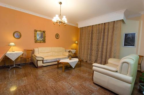a living room with a couch and a table at Orion Studios in Loutra Edipsou