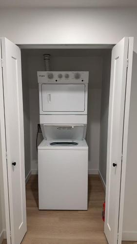 a small kitchen with a white stove in a room at Basement suite -Langley Willoughby in Langley