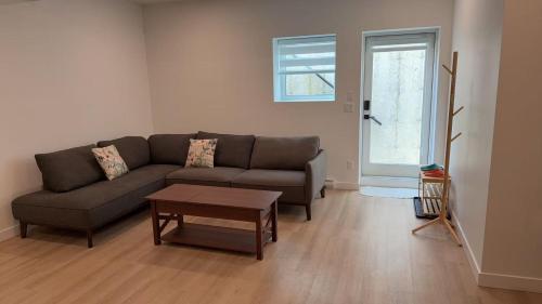 a living room with a couch and a table at Basement suite -Langley Willoughby in Langley