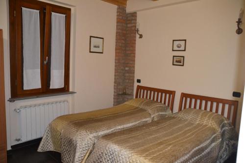 Postel nebo postele na pokoji v ubytování B&B Il Rustico