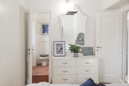 a white bathroom with a dresser and a toilet at In the Historic Village - Riva Lago 10 in Carate Urio