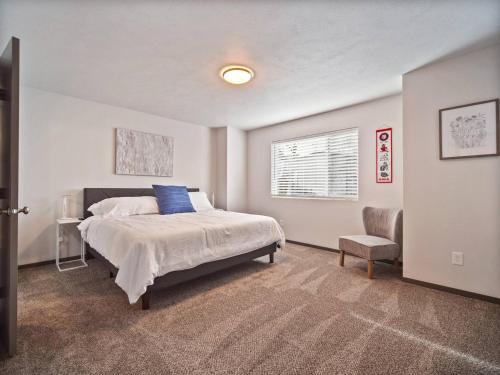 a bedroom with a bed and a chair and a window at 1mile To Arenagonzagaetc Wd, Off St Parking in Spokane