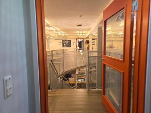 a hallway with a staircase in a building at Norrqvarn Hotel & Resort by Vänerport in Lyrestad