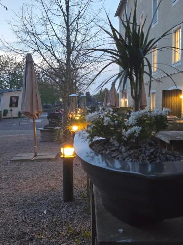 a large stone planter with lights in front of a building at Norrqvarn Hotel & Resort by Vänerport in Lyrestad