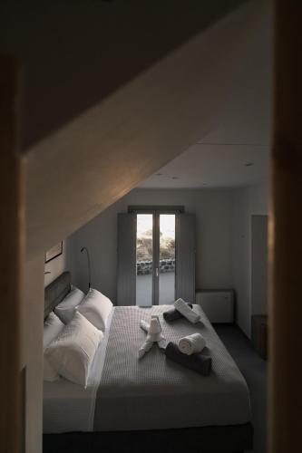 a bedroom with a large bed with towels on it at Uranides Luxury Suites in Santorini