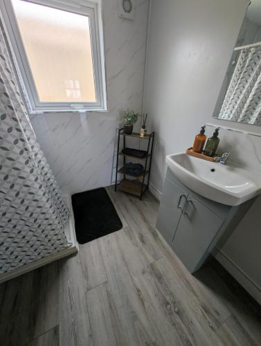 a bathroom with a sink and a mirror at Fountain Street in Bessbrook