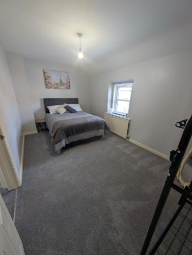 a bedroom with a bed and a window at Fountain Street in Bessbrook