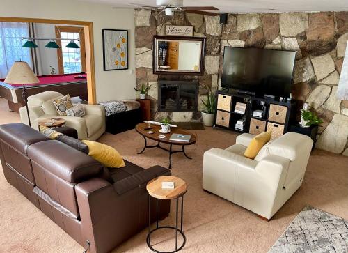 a living room with couches and a flat screen tv at Cheerful Single Story 3-bedroom home w pool table in Santa Clarita