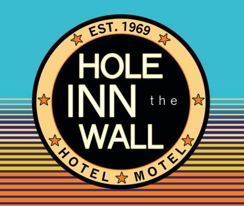 a sign that reads hoe inn the wall at Hole Inn the Wall Hotel - Fort Walton Beach - Sunset Plaza - nearby Beaches & Hurlburt in Fort Walton Beach