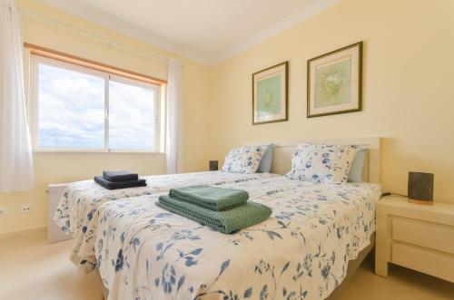 a bedroom with a bed with two pillows on it at Four Bedroom Villa with private pool Oasis Parque AT09 in Portimão