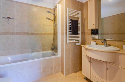 a bathroom with a tub and a sink and a shower at Four Bedroom Villa with private pool Oasis Parque AT09 in Portimão