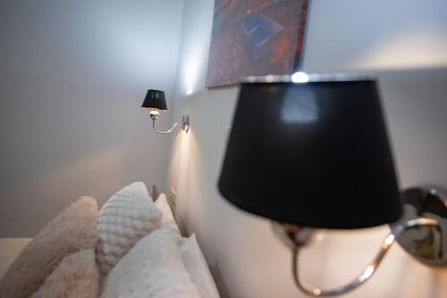a lamp on a wall with a light on it at Chez Kiki et Ioannis in Naxos Chora