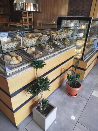 a bakery with a display case filled with lots of pastries at Imperial Palace Hotel EVN in Pʼarakʼar