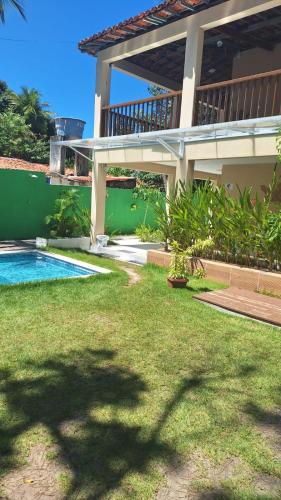 a house with a swimming pool in a yard at Caminho do Paraíso in Porto De Galinhas