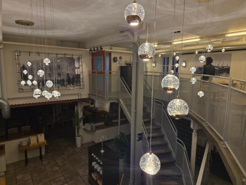 a room with a staircase with chandeliers at Norrqvarn Hotel & Resort by Vänerport in Lyrestad