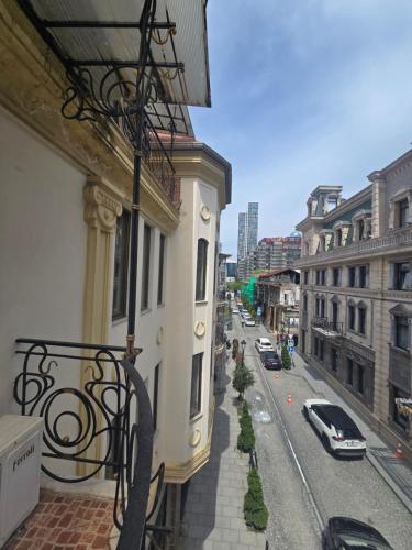 a balcony of a building on a city street at Ritsa Boutique Hotel in Batumi