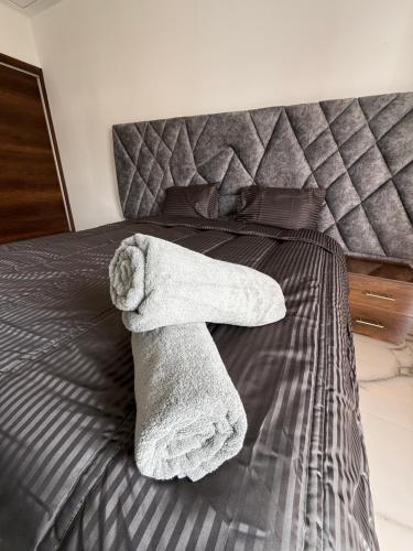 a towel is laying on a bed at Villa Piscine Jacuzzi Saïdia 3 chambres in Saidia 