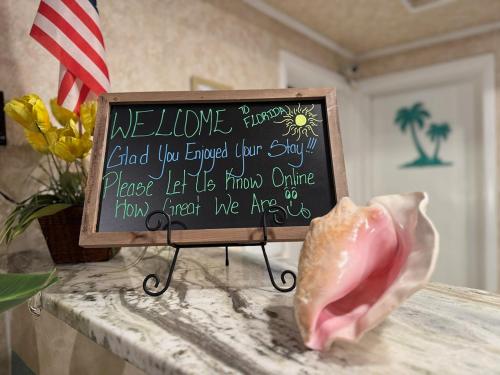a sign sitting on a counter with a ham on a table at Hole Inn the Wall Hotel - Fort Walton Beach - Sunset Plaza - nearby Beaches & Hurlburt in Fort Walton Beach