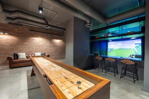 a ping pong table in a room with a television at New Luxury Apt Downtown with Pool in Stamford