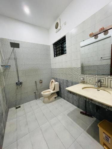 a bathroom with a toilet and a sink at Ayan stay inn in Dargai