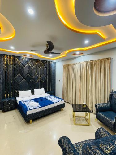 a bedroom with a bed and a couch at Ayan stay inn in Dargai