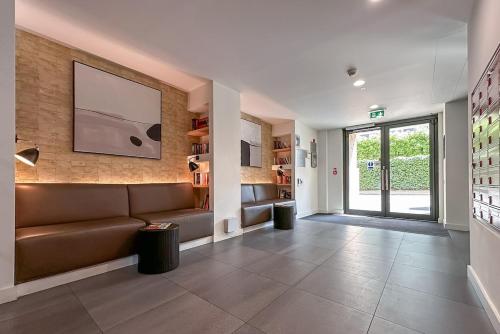 a living room with a couch and a large window at Stunning Apartment with Private Terrace in London