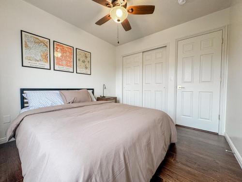 a bedroom with a bed and a ceiling fan at Family Retreat Near SLC Airport 6 BR 3 Bath in West Valley City