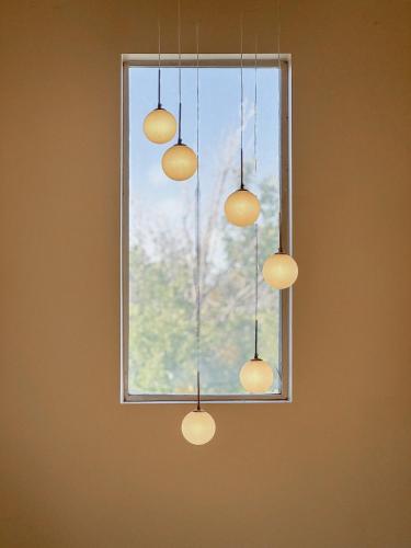 a group of lights hanging from a window at Family Retreat Near SLC Airport 6 BR 3 Bath in West Valley City
