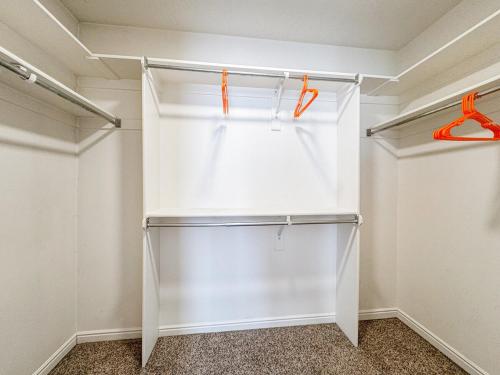 a white walk in closet with orange handles at Family Retreat Near SLC Airport 6 BR 3 Bath in West Valley City