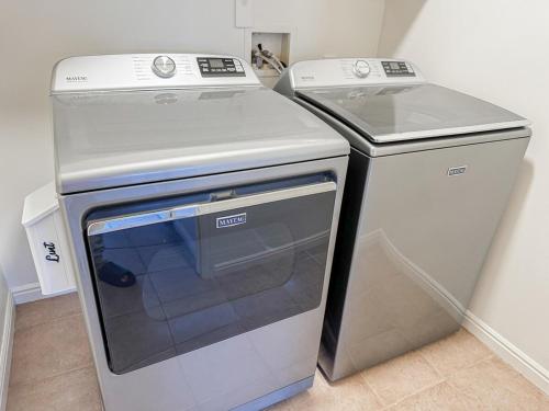 a stove and a refrigerator in a kitchen at Family Retreat Near SLC Airport 6 BR 3 Bath in West Valley City