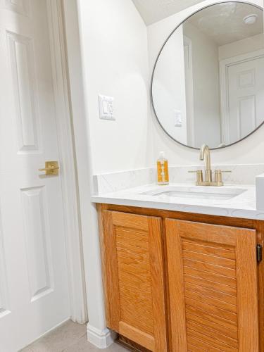 a bathroom with a sink and a mirror at Family Retreat Near SLC Airport 6 BR 3 Bath in West Valley City