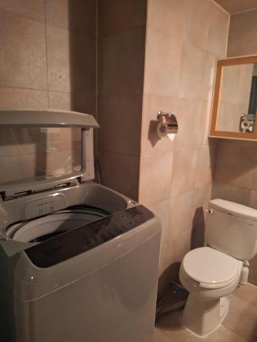a small bathroom with a toilet and a printer at 유성온천역근처 현대 in Daejeon