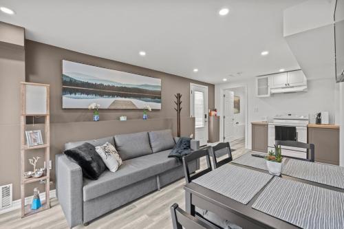 a living room with a couch and a table at Entire 5 bedrooms House in Barrie