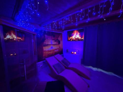 a dark room with a bed with purple lighting at Za Teresa - Napoleonic Private Resort & Spa - Entire property only in Giuliano Teatino