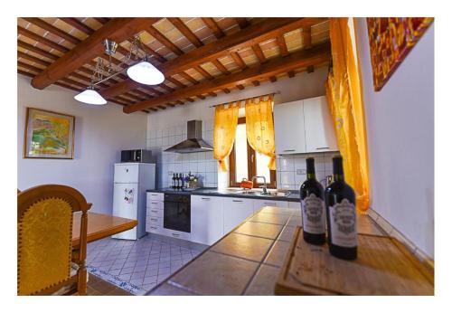 a kitchen with bottles of wine on a table at Za Teresa - Napoleonic Private Resort & Spa - Entire property only in Giuliano Teatino