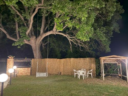 a table and chairs in a yard with a tree at Za Teresa - Napoleonic Private Resort & Spa - Entire property only in Giuliano Teatino