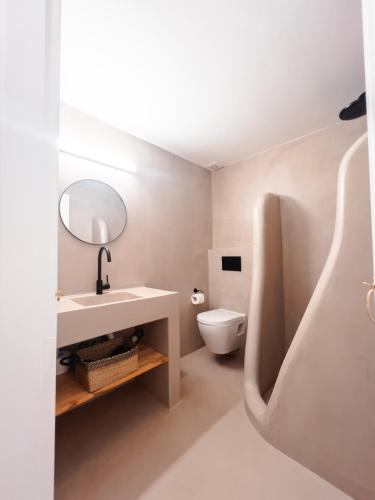a bathroom with a sink and a toilet at Living Blue Tinos in Kardiani