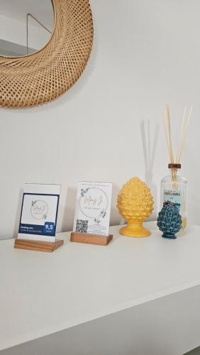 a shelf with three cards and vases on it at Mary J Apartment in Trapani